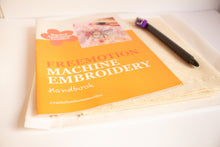 Load image into Gallery viewer, Freemotion Machine Embroidery Handbook on a white surface with an erasable fabric pen next to it