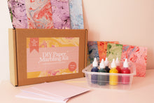 Load image into Gallery viewer, Close-up of marbled paper created using the DIY Paper Marbling Kit, highlighting intricate and colorful patterns.