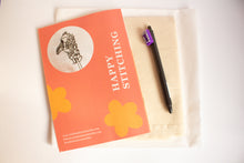 Load image into Gallery viewer, Machine embroidery handbook back cover titled 'Happy Stitching' with a fabric pen on calico and interfacing