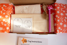Load image into Gallery viewer, Craft kit containing gift tags, templates, and a fabric pen on a white surface with floral patterned paper.